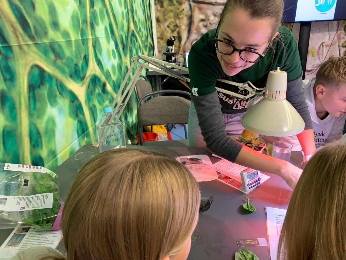Kvinna instruerar ett barn i en laboratoriemiljö