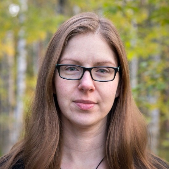 A headshot of a woman with long hair.