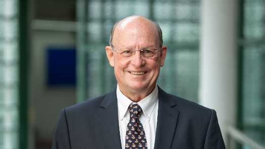 A smiling man in a costume. Photo.