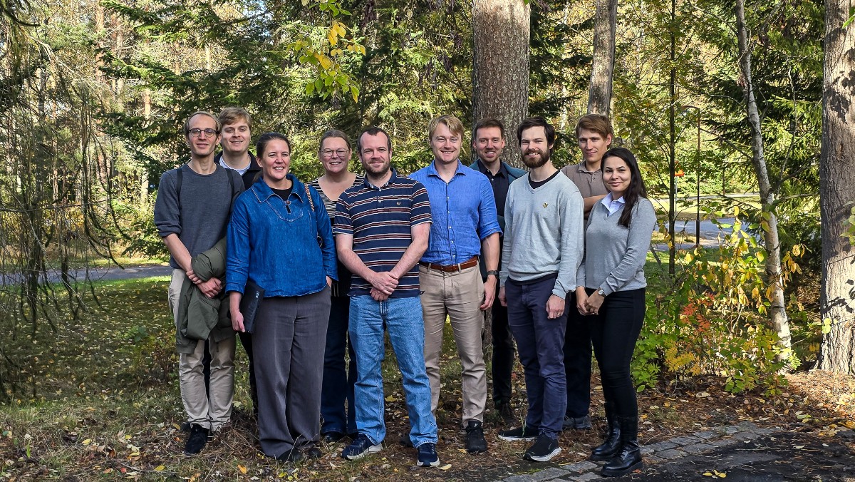 A group of people visiting a forest research site.