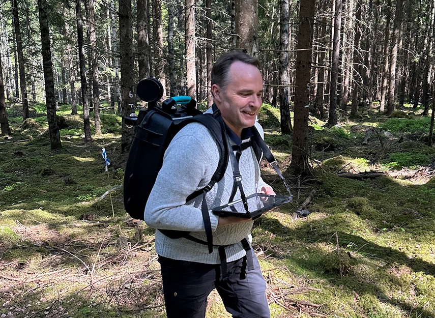 man med ryggsäck i skogen